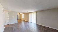 Located at 415 Sylvia Drive in Forest Park, GA, this single-story 2-bedroom, 1-bathroom home offers a functional and well-appointed layout. The open living room is a standout feature, showcasing durable hardwood-style flooring, neutral-toned walls, a textured ceiling, and a ceiling fan. Vertical blinds frame a large sliding glass door that fills the space with natural light and provides outdoor access. The renovated kitchen is both practical and attractive, equipped with crisp white shaker-style cabinetry, light granite-look countertops, white subway tile backsplash, black appliances including a gas range and dishwasher, and a stacked washer and dryer unit—offering the convenience of in-unit laundry. Light vinyl plank flooring completes the kitchen's clean aesthetic. The spacious primary bedroom features hardwood-style flooring and closet access, while the secondary bedroom offers plush carpeting and a large window that invites ample natural light. The full bathroom includes a tiled tub-shower combination, light vinyl flooring, and a vanity. Throughout the home, a consistent neutral color palette and updated finishes create a cohesive, move-in ready environment.