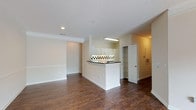 This two-floor residence in Davis, Cary, NC, offers a practical and cohesive layout with consistent design details carried throughout. Rich, dark wood-style flooring runs across the main living areas, complementing the neutral, light-toned walls and white trim found in every room.

The main living area is open and spacious, flowing directly into the kitchen. The kitchen features white cabinetry, dark countertops, and a distinctive black-and-white checkered tile backsplash that adds a bold visual contrast. A double sink, ample cabinet storage, and a white range complete the space.

Adjacent to the living area, a door provides access to an outdoor area, allowing natural light to filter in. Additional rooms benefit from multiple windows, offering views of the surrounding greenery and keeping the interiors bright. A ceiling fan is installed in one of the larger rooms, enhancing comfort and airflow.

The bathroom includes a white vanity with dark countertops, a large mirror, and a soaking tub accented with matching checkered tile trim, tying the design aesthetic together. Closet access is conveniently located nearby.

The attached garage is generously proportioned with a smooth concrete floor, textured ceiling, and an automatic garage door opener, providing practical utility and secure parking.