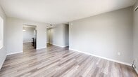 This 2-bedroom, 2-bathroom unit in Tampa, Florida offers a well-designed single-floor layout that makes efficient use of its space. Consistent wood-look flooring flows throughout, lending a cohesive and modern feel to every room. Textured walls and ceilings add character, while neutral gray tones create a calm, versatile backdrop throughout the home.

The galley-style kitchen is a standout feature, outfitted with crisp white cabinetry, granite-look countertops, a stainless steel sink, and black appliances including a range and refrigerator. A pendant light fixture adds a touch of warmth, and the kitchen opens directly into the living and dining area, which benefits from natural light via a large window with outdoor views.

The living room is generously proportioned, with wood-look floors continuing throughout and access to a private patio through vertical blinds. Both bedrooms are well-sized, each with its own closet—one featuring sliding doors—and windows that bring in natural light. The primary bedroom offers a comfortable footprint ideal for a full bedroom suite.

The two bathrooms are clean and functional: one includes a tub/shower combination, and the other a walk-in shower, both with wood-look flooring and white fixtures. A hallway, two closets, and a dedicated utility room round out the practical layout of this Tampa residence.