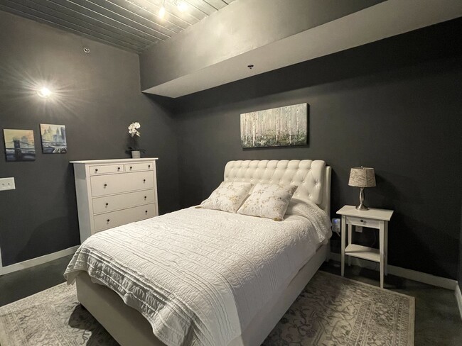 Bedroom with wall mounted smart tv & walk-in closet - 620 Glen Iris Dr NE
