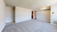 Located at 6004 Amberwood Rd in Baltimore, MD, this 2-bedroom, 1-bathroom unit offers a practical and well-organized single-floor layout. The living area is generously proportioned, featuring soft wall-to-wall carpeting and neutral tones that create a clean, bright atmosphere. Large windows dressed with blinds allow natural light to fill the space and provide views of the surrounding area. The open sightlines between the living space and kitchen contribute to an efficient, connected flow throughout the unit. The kitchen is equipped with rich, warm-toned wood cabinetry, granite-style countertops, a stainless steel sink, and white appliances including an electric range and full-size refrigerator, all set on durable tile flooring. The spacious primary bedroom offers ample room for furnishings, plush carpeting, and a double closet for generous storage. The second bedroom, also carpeted, receives natural light from a window and provides a comfortable, versatile space. The bathroom features a full tub-shower combination with white tile surround, maintaining a clean and functional aesthetic. Overall, this unit presents a straightforward, no-frills living environment suited for those seeking practicality and comfort in Baltimore.
