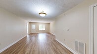 Located at 4172 Bridgewater Pkwy in Stow, Ohio, this single-floor, 3-bedroom, 2-bathroom residence offers a practical and comfortable layout. The living room serves as the heart of the home, featuring warm hardwood-style flooring, neutral toned walls, a textured ceiling, and a window that allows natural light to fill the space. It opens conveniently toward the kitchen, which is equipped with white cabinetry accented by wood-tone upper shelving, a double sink, a full suite of white appliances including a range and refrigerator, and durable hardwood-style flooring — all complemented by bright overhead lighting.

The three bedrooms feature plush carpeting and neutral walls, providing a clean, move-in-ready feel. The spacious primary bedroom benefits from natural light through a large window, and includes access to a walk-in closet outfitted with wire shelving for organized storage. The two full bathrooms mirror one another in design, each featuring a tub/shower combo, a toilet, a single-sink vanity with a wide mirror, and the same warm hardwood-style flooring found throughout the common areas. A hallway connects the rooms, creating a cohesive and efficiently designed floor plan throughout the residence.