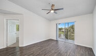This 610 square foot apartment in Port Saint Lucie, Florida offers a practical and contemporary living space. The single-floor layout comprises one bedroom, one bathroom, a kitchen, living room, and hallway. The modern kitchen is a standout feature, boasting light wood cabinetry, black appliances, and a convenient breakfast bar that opens to the living area. Durable laminate flooring runs throughout the main living spaces, while the bedroom features plush carpeting for comfort.

The living room is bathed in natural light from large sliding glass doors, which lead to a private balcony offering outdoor views. The spacious primary bedroom, measuring 180 square feet, includes a ceiling fan and ample windows. The bathroom is efficiently designed with a single vanity and combined tub/shower unit.

The apartment's neutral color palette and open floor plan create a sense of spaciousness, while ceiling fans in multiple rooms provide air circulation. The property's location at 7499 Pine Lakes Blvd offers residents the convenience of Port Saint Lucie living in a compact, well-designed space.