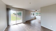 Located at 1 Spyglass Pkwy in Vallejo, California, this single-floor residence offers a thoughtfully designed layout with a clean, contemporary aesthetic throughout. The living area is bright and welcoming, featuring wood-look flooring, neutral gray walls, and large sliding glass doors that open to a green outdoor space, filling the room with natural light. A ceiling fan adds practical comfort, and multiple windows further enhance the airy feel of the space.

The kitchen is well-appointed with dark espresso cabinetry, light quartz countertops, and a full suite of stainless steel appliances including a refrigerator, range, built-in microwave, and dishwasher. Wood-look flooring continues throughout, giving the kitchen a cohesive and modern finish.

The bedrooms offer plush carpeting and generous proportions. One bedroom features a large window with views of lush greenery, providing a calm and private retreat.

Two bathrooms serve the unit. The first includes a dark-toned vanity with a light countertop, a framed mirror, and wood-look flooring. The second bathroom features a tub-shower combination, a single-sink vanity with a stone-look countertop, and a mirror with built-in lighting. Both bathrooms are finished in a clean, neutral palette that complements the overall design of the home.