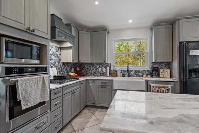 Kitchen with soft close cabinets, newer appliances, and gas range. - 358 Twin Oaks Dr