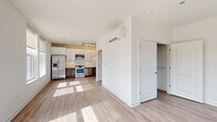 Located at 4733 North Wolcott Avenue in Chicago's vibrant Ravenswood neighborhood, this thoughtfully designed single-floor unit offers a clean, modern aesthetic throughout. Light wood-tone flooring flows seamlessly across the open-concept living area, reflecting abundant natural light that pours in through a set of large windows framing neighborhood views. The open layout connects the living space directly to the kitchen, creating an airy, functional flow. The kitchen is well-appointed with stainless steel appliances — including a gas range, built-in microwave, refrigerator with ice maker, and dishwasher — complemented by white upper cabinetry, warm-toned lower cabinets, light countertops, and a classic subway tile backsplash. A wall-mounted mini-split system provides efficient climate control throughout the space. The bathroom features a full tub-shower combination with clean white tile surround and chrome fixtures. Two closets offer practical storage, and a dedicated laundry area adds everyday convenience. White panel doors, crisp white walls, and recessed and track lighting throughout complete the bright, contemporary character of this well-organized Chicago residence.
