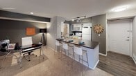 This single-floor residence offers a thoughtfully designed layout that balances comfort and functionality across its key living areas. The kitchen is equipped with stainless steel appliances, white cabinetry, track lighting, and a dark-countertop breakfast bar with seating for multiple guests — flowing seamlessly into a dedicated dining or workspace area with carpeted flooring. The living room is a welcoming, light-filled space anchored by a bold grey accent wall, ceiling fan, and a sliding glass door that draws in natural light and provides outdoor access. Neutral carpet and contemporary décor give the room a relaxed yet polished feel. The primary bedroom features plush carpeting, a ceiling fan, a walk-in closet with organizational shelving, and direct access to a private bathroom. The en-suite bath includes white cabinetry, a dark countertop vanity, a lighted mirror, and wood-look flooring. A second bedroom mirrors the comfort of the primary, offering its own walk-in closet, ceiling fan, and natural light from a well-placed window. Throughout, the residence maintains a cohesive neutral color palette with warm accent walls, creating a modern and inviting atmosphere.