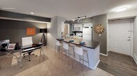 This single-floor residence offers a thoughtfully designed layout that balances comfort and functionality across its key living areas. The kitchen is equipped with stainless steel appliances, white cabinetry, track lighting, and a dark-countertop breakfast bar with seating for multiple guests — flowing seamlessly into a dedicated dining or workspace area with carpeted flooring. The living room is a welcoming, light-filled space anchored by a bold grey accent wall, ceiling fan, and a sliding glass door that draws in natural light and provides outdoor access. Neutral carpet and contemporary décor give the room a relaxed yet polished feel. The primary bedroom features plush carpeting, a ceiling fan, a walk-in closet with organizational shelving, and direct access to a private bathroom. The en-suite bath includes white cabinetry, a dark countertop vanity, a lighted mirror, and wood-look flooring. A second bedroom mirrors the comfort of the primary, offering its own walk-in closet, ceiling fan, and natural light from a well-placed window. Throughout, the residence maintains a cohesive neutral color palette with warm accent walls, creating a modern and inviting atmosphere.