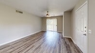 Located at 14100 Rio Bonito Rd in Houston, TX, this two-story home offers five bedrooms and four bathrooms thoughtfully distributed across two evenly sized floors. The main level welcomes you with a bright, open living room featuring durable wood-look flooring, neutral-toned walls, and a ceiling fan that provides both comfort and style. A sliding glass door floods the space with natural light and provides access to the patio. The kitchen is well-appointed with crisp white shaker cabinets, granite-style countertops, a peninsula for additional prep space, and black appliances including a range and refrigerator. A dedicated pantry adds convenient storage. Staircases connect both levels, with hallways guiding the flow between rooms. The bedrooms are carpeted for comfort, each featuring windows with blinds that invite natural light while maintaining privacy. Six closets throughout the home ensure ample storage. The bathrooms are finished with granite-topped vanities, white cabinetry, and wood-look flooring. A dedicated laundry room adds everyday practicality. With a clean, neutral palette and modern finishes throughout, this home presents a functional and comfortable living environment suited for a large household.