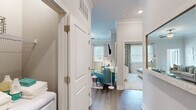 Located at 3000 Brushy Mountain St in Cary, NC, this well-appointed 2-bedroom, 2-bathroom residence offers a single-floor layout that maximizes functionality and comfort. The living room serves as the heart of the home, featuring a fireplace with a clean surround, crown molding, a ceiling fan, and large windows with access to an outdoor balcony that invites natural light throughout. Adjacent, the dining area continues the refined aesthetic with chair rail molding, hardwood-style flooring, and generous window views. The kitchen is equipped with granite countertops, a white subway tile backsplash, taupe cabinetry, and stainless steel appliances including a refrigerator and dishwasher. The primary bedroom offers a comfortable retreat with plush carpeting and access to a private en-suite bathroom, which features a double vanity with gray cabinetry, a glass-enclosed shower, hardwood-style flooring, and a spacious walk-in closet with built-in shelving. The second bedroom is well-sized with carpeted floors, a ceiling fan, and ample natural light. The second bathroom includes a tub-shower combination with tiled surround and hardwood-style flooring. Two closets provide additional storage throughout the home.