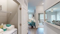 Located at 3000 Brushy Mountain St in Cary, NC, this well-appointed 2-bedroom, 2-bathroom residence offers a single-floor layout that maximizes functionality and comfort. The living room serves as the heart of the home, featuring a fireplace with a clean surround, crown molding, a ceiling fan, and large windows with access to an outdoor balcony that invites natural light throughout. Adjacent, the dining area continues the refined aesthetic with chair rail molding, hardwood-style flooring, and generous window views. The kitchen is equipped with granite countertops, a white subway tile backsplash, taupe cabinetry, and stainless steel appliances including a refrigerator and dishwasher. The primary bedroom offers a comfortable retreat with plush carpeting and access to a private en-suite bathroom, which features a double vanity with gray cabinetry, a glass-enclosed shower, hardwood-style flooring, and a spacious walk-in closet with built-in shelving. The second bedroom is well-sized with carpeted floors, a ceiling fan, and ample natural light. The second bathroom includes a tub-shower combination with tiled surround and hardwood-style flooring. Two closets provide additional storage throughout the home.