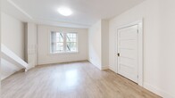 Located at 929 SW Salmon Street in the heart of Portland, Oregon, this efficiently designed single-floor unit offers a well-organized layout comprising a kitchen, bathroom, and hallway. Light-toned, hardwood-style flooring runs throughout, complementing the bright white walls and creating a clean, cohesive aesthetic.

The kitchen is a functional standout, featuring dark espresso-stained cabinetry with brushed hardware on both upper and lower cabinets, white countertops, a gas range, a full-size refrigerator, and a utility hood. The contrast between the dark cabinetry and the light walls and floors gives the kitchen a bold, contemporary character.

The bathroom retains a classic charm with its freestanding clawfoot soaking tub equipped with an overhead shower fixture, a pedestal sink, and a window that allows natural light to filter in, keeping the all-white space feeling open and airy.

The living area benefits from a large multi-pane window that draws in natural light and offers views of the surrounding neighborhood. A paneled door and clean white trim add traditional architectural detailing throughout.

The hallway connects the spaces efficiently, maintaining the unit's streamlined flow. Overall, the unit presents a blend of classic character and updated finishes in a compact, practical footprint ideally situated in downtown Portland.