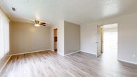 Located at 5865 Buckeye Ln in Mentor-on-the-Lake, Ohio, this two-story home offers a straightforward, functional layout spread across two well-defined levels. The main floor features an open living area finished with light-toned luxury vinyl plank flooring that extends throughout, lending a clean and cohesive feel to the space. A ceiling fan with integrated lighting occupies the living area, while a sliding glass door fitted with vertical blinds draws in natural light and provides access to the exterior. The textured ceilings are consistent throughout the main level. Adjacent to the living area, a galley-style kitchen is equipped with white cabinetry, granite-look countertops, a single-basin sink, and a full-size refrigerator. A bathroom on the lower level includes wood-look flooring and basic fixtures.

The upper level houses the bedrooms, each finished with neutral wall-to-wall carpet and individual closets, including one room featuring bifold-door double closets with built-in shelving and rods. A full bathroom on the upper level includes a white vanity, a tub-shower combination, and wood-look flooring. A staircase with a metal railing connects both floors, contributing to the home's practical two-story design.