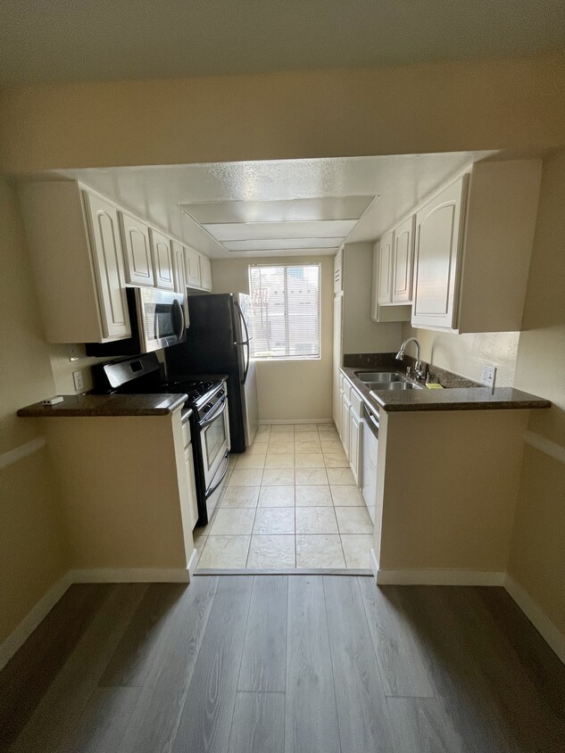 Kitchen with refrigerator, microwave, dishwashers, stove - 10960 Bluffside Dr