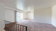 Located in Mount Joy, PA, this two-bedroom, one-bathroom home offers a practical and comfortable layout across a single level. The living area is generously sized, featuring soft carpeting, a ceiling fan, and a sliding glass door that opens to a private balcony, allowing natural light to fill the space. A staircase with a metal railing leads to the entry level below, adding an architectural element to the open layout.

The kitchen is efficiently designed with warm honey-toned wood cabinetry, ample counter space, and durable hardwood-style flooring. It is equipped with a full suite of white appliances, including a refrigerator, electric stove, and dishwasher, making it a functional space for everyday cooking.

The spacious primary bedroom features plush carpeting and direct access to a dedicated walk-in closet, offering excellent storage. The second bedroom is well-proportioned with carpeted flooring and a window that brings in natural light. A programmable thermostat is conveniently located nearby for climate control.

The bathroom includes a full tub and shower combination with chrome fixtures. Throughout the home, neutral tones and clean finishes create a calm, move-in-ready atmosphere suited for comfortable everyday living.
