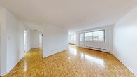 Located at 5501 Avenue Adalbert in the desirable Côte-Saint-Luc neighbourhood of Montreal, this 3-bedroom, 1-bathroom apartment offers a practical and well-organized layout. Classic parquet flooring runs throughout the living areas and bedrooms, adding warmth and a timeless character to the space.

The spacious living room is bright and open, benefiting from large windows that invite generous natural light and offer views of the surrounding neighbourhood. The room provides ample space for comfortable living and entertaining. The kitchen features white cabinetry with modern hardware, light-toned countertops, white tile flooring, and stainless steel appliances including a refrigerator, stove, and dishwasher — offering a clean and functional cooking environment.

The three bedrooms are well-sized, with the primary bedroom being notably generous. Each bedroom is finished with the same warm parquet flooring and benefits from windows that bring in natural light. One bedroom includes a built-in closet for added storage. The bathroom is equipped with a full bathtub and tiled surround, maintaining a simple and clean aesthetic. A hallway connects the rooms efficiently, completing this straightforward and livable floor plan.