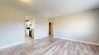 Located at 108 Chris Dr in Warner Robins, Georgia, this 2-bedroom, 1-bathroom home offers a practical and well-maintained single-floor layout. Light-toned laminate wood flooring runs consistently throughout the home, lending a clean and cohesive aesthetic to every room.

The living room is an open, airy space with neutral-toned walls, a textured ceiling, and direct sightlines into the kitchen, creating a connected and functional flow. The kitchen is equipped with white cabinetry, granite-look countertops, a stainless steel refrigerator, and a black gas range, complemented by a window that brings in natural light.

The primary bedroom is generously sized, featuring a walk-in closet and windows fitted with horizontal blinds that offer neighborhood views. The second bedroom is a comfortable, well-proportioned room with its own window providing natural light and outdoor views of the surrounding area. Both bedrooms maintain the same consistent flooring and neutral color palette found throughout the home.

The bathroom includes a full-size soaking tub and shower combination with chrome fixtures and a window above for added ventilation and light. A connecting hallway ties the rooms together efficiently. Overall, the home presents a clean, move-in-ready environment with updated finishes and a practical, straightforward design.
