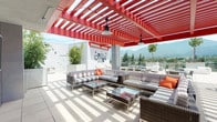 Located at 1622 S Magnolia Ave in Monrovia, CA, this expansive rooftop amenity deck at Moda at Monrovia Station offers a thoughtfully designed outdoor retreat with sweeping views of the San Gabriel Mountains. The space is defined by a striking red pergola structure that anchors the rooftop with bold architectural character, casting dramatic striped shadows across the light-toned tile flooring throughout the day.

The lounge area features generous sectional seating with striped upholstery and woven rattan frames, accented by vibrant orange throw pillows and paired with glass-top coffee tables — ideal for relaxed gatherings. Pendant barn-style lights hang from the pergola overhead, adding functional charm.

An outdoor kitchen and bar station provide excellent entertaining capabilities, complete with a large gas grill, granite-topped counters, a wall-mounted television, wood-panel accent wall, and bar seating. A separate dining table with chairs offers additional al fresco meal options. Sun loungers provide a dedicated space for relaxation, while recreational amenities including cornhole boards and a oversized Connect Four game add a playful touch. The entire deck is bordered by open railings that maximize the breathtaking mountain and cityscape panorama.