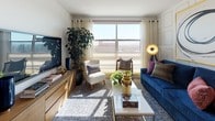 This single-floor residence showcases a thoughtfully designed layout with a cohesive contemporary aesthetic. The kitchen is a standout feature, equipped with stainless steel appliances including a gas range, microwave, and French door refrigerator. Flat-front wood-tone cabinetry extends to the ceiling, complemented by white quartz countertops, a subway tile backsplash with under-cabinet lighting, a stainless steel sink, and light wood-look flooring that adds warmth throughout.

The living room receives generous natural light through large windows offering open city views. Decorative wall paneling lends architectural character, while an open connection to the bedroom enhances the sense of flow. The bedroom features plush carpeting, a bold geometric accent wall, ample window exposure, a large mirror wall, and a sliding barn-style door for privacy.

Two bathrooms serve the residence with distinct designs. One features a soaking tub with shower curtain, a floating wood vanity with white countertop, textured wall tile in warm brown tones, and a large mirror. The second bathroom offers a spacious walk-in glass-enclosed shower, a matching floating vanity, navy blue accent wall, and large-format floor tile. Both bathrooms are finished with soft bath rugs and curated décor details.