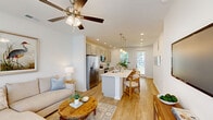 Located at 400 Claysburg Loop in Bloomingdale, Georgia, this well-designed single-story home offers a thoughtfully organized layout across one bedroom and one bathroom. Light wood-tone flooring runs throughout, complementing the crisp white walls and creating a bright, cohesive aesthetic. The kitchen is well-appointed with gray shaker-style cabinetry, white countertops, a subway tile backsplash, stainless steel appliances, and recessed lighting. A dining area adjacent to the kitchen features a glass door that opens to a lush, tree-lined backyard, allowing natural light to pour in. A built-in desk nook with overhead cabinetry adds a functional workspace near the dining space. The living room is open and inviting, highlighted by a ceiling fan, large windows with blinds, a modern entry door with frosted glass panels, and built-in shelving for added storage. The bedroom offers a comfortable retreat with dual windows, a ceiling fan, and warm natural light. The full bathroom features gray vanity cabinetry with ample storage, a walk-in glass-enclosed shower, white tile surround, and recessed lighting. Throughout the home, clean lines, neutral tones, and modern fixtures combine to create a polished and functional living environment.