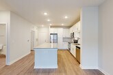 Located at 2465 Richardson Pkwy in Jonesboro, GA, this thoughtfully designed one-bedroom, one-bathroom residence offers a functional and modern living experience across a single floor. The open-concept layout seamlessly connects the kitchen and living room, creating an inviting, airy atmosphere enhanced by wood-style flooring throughout.

The kitchen is a standout feature, boasting white shaker cabinetry, granite countertops, a subway tile backsplash, and a full suite of stainless steel appliances including a refrigerator, electric range, microwave, and dishwasher. A central island provides additional prep space and casual seating.

The living room extends from the kitchen and is filled with natural light from large windows and a glass door that opens to a private balcony, offering outdoor views of the surrounding community. A ceiling fan adds to the comfort of the space.

The bedroom is a comfortable, well-proportioned retreat featuring a ceiling fan, wood-style flooring, and windows that bring in natural light. A dedicated closet provides ample storage.

The bathroom features a tiled tub-shower combination, wood-style flooring, and clean, neutral finishes. A dedicated laundry room with a full-size washer and dryer and overhead shelving adds everyday convenience to this well-rounded home.