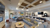 Located in Simpsonville, South Carolina, this thoughtfully designed single-floor community space offers a refined and welcoming environment with a contemporary aesthetic throughout. The centerpiece of the interior is a generous open-concept lounge area anchored by a large sectional sofa, a zebra-print area rug, and a striking coffered ceiling with wood inlay panels and a ceiling fan — a standout architectural detail that adds warmth and visual depth overhead. Rich hardwood flooring runs throughout, grounding the space with a sense of warmth and cohesion. A dramatic stacked-stone accent wall with a fireplace serves as a bold focal point, complemented by large sliding glass doors that flood the space with natural light and provide seamless access to an outdoor patio with seating. The kitchen area is fully equipped with stainless steel appliances, a large quartz-topped island, sleek cabinetry, and a wall-mounted television, making it ideal for gathering and entertaining. Multiple intimate seating nooks are scattered throughout, featuring colorful upholstered chairs in blue and yellow hues alongside curated artwork, including vibrant abstract canvases and textural stone wall sculptures. A welcoming entry foyer with lounge chairs and framed artwork offers a polished first impression. The overall ambiance is modern, artistic, and inviting.