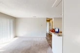 Located at 7200 Powers Ave in Jacksonville, FL, this one-bedroom, one-bathroom residence offers a practical and well-appointed single-floor layout. The open-concept living, dining, and kitchen area forms the heart of the home, with wood-look flooring and neutral-toned walls creating a clean, cohesive aesthetic. A large sliding glass door with vertical blinds invites natural light into the living space, enhancing the sense of openness.

The kitchen is a standout feature, equipped with white shaker-style cabinetry, granite countertops, a classic white subway tile backsplash, and a full suite of stainless steel appliances including a refrigerator, dishwasher, electric range, and over-the-range microwave. A breakfast bar connects the kitchen to the main living and dining area, offering additional counter space and casual seating potential.

The bedroom is generously proportioned, featuring soft carpeting, a window with natural light, and direct access to two closets, providing ample storage. The bathroom includes a tiled tub-and-shower combination with brushed nickel fixtures. Throughout the unit, textured ceilings, consistent neutral finishes, and practical flooring choices contribute to a clean, move-in-ready feel.