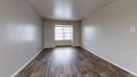 Located at 834 Timberlake Ct in Arlington, TX, this one-bedroom, one-bathroom unit offers a practical and comfortable single-floor layout. The living room makes a strong first impression with rich, dark hardwood-style flooring, neutral gray walls, a textured ceiling, and a window fitted with blinds that allows natural light to fill the space.

The kitchen is thoughtfully appointed with gray cabinetry, light stone-look countertops, a mosaic tile backsplash, a double-basin sink, and black appliances — including a refrigerator and stove — all set atop matching hardwood-style flooring, creating a cohesive aesthetic.

The bedroom is carpeted for warmth and comfort, features a ceiling fan with light fixture, a window with blinds for natural light, and is connected to a hallway via a paneled door. Two closets provide ample storage throughout the unit.

The bathroom includes a full tub-shower combination with white square tile surround, maintaining a clean and functional design.

A connecting hallway ties the rooms together efficiently. Throughout the unit, neutral tones and consistent finishes create a unified, move-in-ready atmosphere well-suited for comfortable everyday living in the heart of Arlington, Texas.