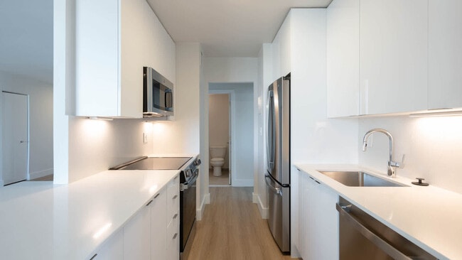Kitchen with Stainless Steel Appliances - The Towers at Longfellow Apartments