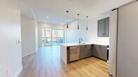 This contemporary 800 square foot apartment in Denver offers a harmonious blend of style and functionality. The open-concept layout seamlessly integrates the living room and kitchen, creating an airy and spacious feel. The kitchen is a highlight, featuring sleek gray cabinetry, stainless steel appliances, and a stylish white backsplash. Pendant lighting adds a touch of modern elegance.

The 160 square foot bedroom is generously sized and includes a spacious closet for ample storage. The bathroom boasts a double vanity with a large mirror and modern fixtures. A separate laundry area with a stacked washer and dryer provides convenience.

Throughout the apartment, light wood-look flooring creates a warm and inviting atmosphere. Large windows flood the space with natural light and offer stunning city views. A private balcony extends the living space outdoors, perfect for enjoying Denver's climate.

The apartment's neutral color palette and clean lines contribute to its modern aesthetic. With its thoughtful design and prime location at 855 N Broadway, this one-bedroom apartment offers a perfect blend of urban living and comfort in the heart of Denver.
