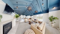 This thoughtfully designed single-floor unit offers a clean, modern aesthetic throughout its efficiently organized layout. The living room is a bright, open space featuring rich hardwood-style flooring, crisp white walls, recessed lighting, and multiple windows — including a glass-paned door — that invite abundant natural light and outdoor views of lush greenery. The room's generous proportions provide a welcoming and versatile living area.

The kitchen is equipped with gray shaker-style cabinetry, granite-look countertops, and a stainless steel dishwasher, offering a contemporary and functional workspace. Conveniently tucked nearby is a dedicated laundry area with a full-size stacked washer and dryer unit.

The bedroom is a comfortable, well-proportioned retreat finished with plush wall-to-wall carpeting and a window that frames outdoor views, creating a calm and restful atmosphere. An adjoining walk-in closet features wire shelving and hanging rods, providing ample storage.

The bathroom completes the layout, and a dedicated closet adds further organizational utility. Throughout the unit, consistent white walls, clean trim work, and a neutral color palette contribute to a bright, move-in-ready ambiance that is both practical and polished.