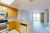 Located at 1855 Saint Francis St in Reston, VA, this one-bedroom, one-bathroom residence offers a thoughtfully designed open-concept layout. The combined living, dining, and kitchen area forms the heart of the home, finished with warm hardwood-style flooring that extends throughout. The kitchen is well-appointed with stainless steel appliances — including a gas range, built-in microwave, dishwasher, and refrigerator — complemented by warm-toned wood cabinetry, granite countertops, and a skylight that floods the space with natural light. A peninsula counter provides additional workspace and casual dining potential. The living area opens directly to a private patio through a full-height sliding glass door, offering expansive panoramic views of the surrounding Reston landscape. The spacious primary bedroom features plush carpeting, ample closet space, and direct sightlines to the kitchen. The bathroom is cleanly finished with tile flooring, a full soaking tub, and a wood-accented vanity. Four closets throughout the unit provide generous storage. A dedicated utility room adds further practicality. The neutral color palette, natural light, and open flow create a bright, functional living environment.