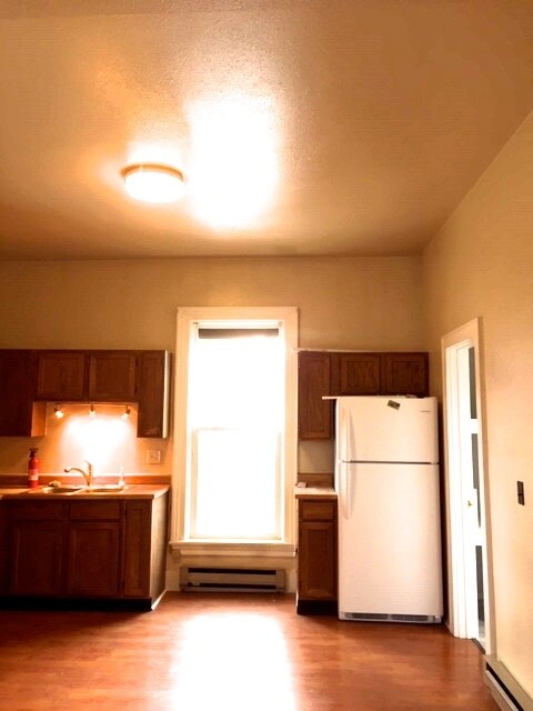 Kitchen with south facing window. New stove installed in early December. - 425 E Broadway St