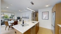 Located at 1133 Warburton Ave in Yonkers, NY, this two-bedroom, two-and-a-half-bathroom residence offers a thoughtfully designed single-floor layout with a clean, modern aesthetic. The open-concept living and dining area flows seamlessly into a well-appointed kitchen, creating an inviting space ideal for both everyday living and entertaining. The kitchen is a standout feature, showcasing a large center island with a crisp white quartz countertop, an undermount sink with a sleek arc faucet, warm wood cabinetry, and stainless steel appliances. A contemporary linear pendant light hangs above the island, adding a polished finishing touch. Light hardwood flooring extends throughout, complementing the bright, neutral color palette and recessed lighting overhead. The dining area comfortably accommodates a full dining set, while the adjacent living space provides a relaxed, open atmosphere. The residence includes two well-sized bedrooms and two and a half bathrooms, offering both comfort and functionality. The overall design balances modern sophistication with a warm, livable character, making this a refined and move-in-ready home in the heart of Yonkers.