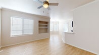 Located at 1601 E Highland Ave in Phoenix, AZ, this well-appointed 2-bedroom, 3-bathroom residence offers a thoughtfully designed single-floor layout. Light wood-style flooring flows throughout the main living areas, complemented by a warm, neutral color palette that creates a bright and welcoming atmosphere. The open-concept living room features built-in wall shelving, a ceiling fan, and multiple windows with blinds that invite abundant natural light. An arched entryway leads into the galley-style kitchen, which is outfitted with dark espresso cabinetry, stainless steel appliances including a refrigerator, range, and microwave, and a peninsula with bold violet accent panels and a white countertop — adding a striking design element. In-unit laundry is conveniently tucked just off the kitchen. The bedrooms offer plush carpet flooring, ceiling fans, and ample natural light, with dedicated closet space in each. The three bathrooms are finished with light wood-style flooring, clean white fixtures, tub-shower combinations, and dark-toned vanities. Two dedicated closets provide excellent storage throughout the home. The overall ambiance is clean, modern, and functional, well-suited to comfortable everyday living in the heart of Phoenix.