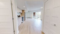 Located at 3250 Boul Henri-Bourassa E in Montréal, this well-designed 3-bedroom, 1-bathroom unit offers a clean, contemporary layout across a single floor. Light wood laminate flooring runs throughout the main living areas and bedrooms, creating a cohesive and airy feel.

The open-concept kitchen is outfitted with light wood and white cabinetry, stainless steel appliances including a fridge, electric range, and dishwasher, complemented by light countertops and ample upper and lower storage. Recessed lighting adds a polished finish to the space.

The living area is bright and open, benefiting from large sliding glass doors that lead to a balcony and allow generous natural light to flow in. A wall-mounted air conditioning unit ensures year-round comfort, and baseboard heating is present throughout.

The primary bedroom is a well-proportioned room featuring a large window with views of the surrounding neighbourhood. The two additional bedrooms are bright, minimalist spaces with light walls and wood flooring, suitable for various uses.

The bathroom is finished in crisp white tiling and features a full bathtub with an overhead shower, offering a clean and functional design. Overall, the unit presents a modern, move-in ready aesthetic with a neutral palette throughout.