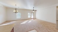 This single-floor residence at 5071 William Flynn Hwy in Gibsonia, PA offers a thoughtfully designed layout with a bright, open feel throughout. The expansive main living and dining area is bathed in natural light from multiple windows and features plush carpeting, a ceiling fan, and an elegant chandelier, creating a comfortable and versatile space for everyday living.

The kitchen is equipped with rich cherry wood cabinetry, light-toned countertops, stainless steel appliances including a gas range, built-in microwave, and dishwasher, along with a double sink positioned near a window. The kitchen flows seamlessly into the main living area, enhancing the open-concept design.

The bedrooms are carpeted and well-sized, each offering natural light through windows with blinds and ceiling fans. Closet storage is generously provided, with one bedroom featuring a spacious walk-in closet outfitted with wire shelving systems, and another bedroom offering a reach-in closet with wire shelving.

Both bathrooms are finished consistently, each featuring a tub-shower combination, a wood vanity with granite countertop, a large mirror, and tile flooring. One bedroom also includes access to an outdoor deck, adding a pleasant connection to the exterior.