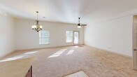 This single-floor residence at 5071 William Flynn Hwy in Gibsonia, PA offers a thoughtfully designed layout with a bright, open feel throughout. The expansive main living and dining area is bathed in natural light from multiple windows and features plush carpeting, a ceiling fan, and an elegant chandelier, creating a comfortable and versatile space for everyday living.

The kitchen is equipped with rich cherry wood cabinetry, light-toned countertops, stainless steel appliances including a gas range, built-in microwave, and dishwasher, along with a double sink positioned near a window. The kitchen flows seamlessly into the main living area, enhancing the open-concept design.

The bedrooms are carpeted and well-sized, each offering natural light through windows with blinds and ceiling fans. Closet storage is generously provided, with one bedroom featuring a spacious walk-in closet outfitted with wire shelving systems, and another bedroom offering a reach-in closet with wire shelving.

Both bathrooms are finished consistently, each featuring a tub-shower combination, a wood vanity with granite countertop, a large mirror, and tile flooring. One bedroom also includes access to an outdoor deck, adding a pleasant connection to the exterior.