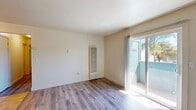 Located at 4550 Shelley Ct in Stockton, CA, this two-bedroom, one-bathroom single-floor unit offers a clean, functional layout with modern updates throughout. Light-toned luxury vinyl plank flooring runs through the main living areas, giving the space a cohesive and contemporary feel.

The living room is a welcoming open area featuring a wall-mounted heater and a sliding glass door that opens to a private balcony, allowing natural light to pour in and offering outdoor views of nearby palm trees. A wall AC unit provides additional climate control.

The galley-style kitchen is efficiently designed with white cabinetry, granite-look countertops, a double sink, and a full suite of white appliances including a refrigerator and electric range. Warm tile flooring and a vertical-blind window complete the space.

Both bedrooms are comfortably sized with LVP flooring and built-in closets. The primary bedroom includes a dedicated closet with double hanging rods and ample storage space. Each bedroom is served by wall vents for heating and cooling.

The bathroom features warm tile flooring, a tiled tub-shower surround, and a classic white fixture set. A hallway connects all rooms, adding to the efficient flow of the layout. The unit also includes a dedicated closet for additional storage.