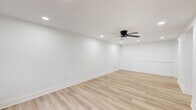 Located at 2170 Fort Harrods Dr in Lexington, KY, this 2-bedroom, 1-bathroom home delivers a clean, modern aesthetic throughout its efficiently designed single-floor layout. The open living room greets you with light wood luxury vinyl flooring, recessed lighting, a ceiling fan, and crisp white walls that create a bright, airy atmosphere. The well-appointed kitchen is a standout feature, showcasing white shaker cabinetry with matte black hardware, granite countertops, a classic white subway tile backsplash, a stainless steel dishwasher, range, microwave, and refrigerator, along with an open floating shelf for added character. Both bedrooms are carpeted for comfort and each is equipped with individual wall-mounted mini-split units for independent climate control. The primary bedroom also features a ceiling fan and a window that brings in natural light. The bathroom continues the home's modern theme with light wood-tone flooring, white cabinetry, matte black fixtures, and a full tub-shower combination. A dedicated laundry room with a full-size washer and dryer adds everyday convenience. Every detail reflects a fresh, contemporary finish throughout.