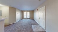 Located at 2001 S Lyerly St in Chattanooga, TN, this single-floor, 2-bedroom, 2-bathroom unit offers a practical and comfortable layout. The open-concept living and dining area is carpeted and filled with natural light through a set of French doors that lead to the exterior, creating a welcoming and airy atmosphere. A tiled entryway transitions smoothly into the carpeted living space.

The kitchen is positioned adjacent to the living area, separated by a breakfast bar with a light-toned countertop. Warm oak cabinetry lines the walls, offering generous storage, while white appliances including a refrigerator and range complete the functional cooking space.

A hallway connects the living area to the two bedrooms and two full bathrooms. Each bedroom features plush carpet flooring and windows that bring in natural light. The primary bedroom is a comfortable size and includes a closet with built-in shelving. Both bathrooms are finished with tile flooring, light oak vanities with single sinks, large mirrors with bar lighting above, and a shower-tub combination.

Two closets provide additional storage throughout the unit. The warm neutral color palette and consistent finishes across all rooms contribute to a cohesive and functional living environment.