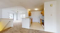 Located at 1069 Heritage Park Dr in Webster, NY, this well-appointed 2-bedroom, 2-bathroom single-floor home offers a comfortable and functional layout. The entryway welcomes you with vaulted ceilings, tile flooring, and a large window fitted with blinds that fills the space with natural light. The open-concept kitchen and living area is a highlight of the home, featuring warm honey-toned cabinetry, white appliances including a refrigerator, electric range, microwave, and dishwasher, as well as a breakfast bar peninsula that connects seamlessly to the living room. The living room boasts striking vaulted ceilings, a ceiling fan, and large windows that overlook the surrounding neighborhood, creating a bright and airy atmosphere. Soft carpet flows throughout the living spaces and bedrooms. The primary bedroom is generously sized and is accompanied by a full bathroom featuring a vanity with warm wood cabinetry, a soaking tub, and tile flooring. A spacious walk-in closet with wire shelving provides ample storage. The second bedroom also features large windows and plush carpeting. Additional highlights include a dedicated laundry room and a second closet, rounding out this practical and comfortable home.