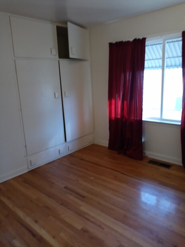 Bedroom 2 hardwood floors and lots of storage - 564 W 10th St