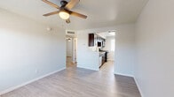 Located at 814 E Ninth St in Tucson, AZ, this single-story, 3-bedroom, 1-bathroom home offers a well-designed layout that maximizes every square foot. Light wood-style flooring flows consistently throughout, lending a clean, cohesive feel to the entire residence. Each bedroom is thoughtfully sized, featuring ceiling fans for year-round comfort and windows with blinds that invite natural light. The primary bedroom includes a built-in closet with a hanging rod, providing practical storage. The kitchen stands out with rich dark cabinetry, granite-style countertops, a stainless steel double-basin sink, and a full suite of appliances including a gas range, built-in microwave, dishwasher, and refrigerator. It opens toward the living area, creating a connected and functional common space. The bathroom is a highlight of the home, finished with classic white subway tile surrounding the tub-shower combo, accented by a decorative mosaic tile border. A dark vanity with a granite-top countertop and wood-style flooring complete the refined look. A hallway connects the bedrooms and bathroom, keeping the floor plan organized. Ceiling fans throughout, neutral wall tones, and consistent modern finishes give this home a fresh, move-in-ready appeal.