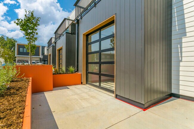 ground floor flex space garage style door for open air living - 3271 Airport Rd
