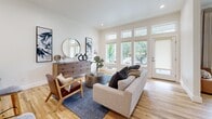 Located in the heart of Dallas's sought-after Lower Greenville neighborhood, this single-story 1-bedroom, 1-bathroom home offers a thoughtfully designed open-concept layout with clean modern finishes. Light oak hardwood floors flow seamlessly throughout every room, creating a warm and cohesive aesthetic.

The combined kitchen and living area forms the heart of the home. The kitchen is outfitted with sleek white flat-panel cabinetry, quartz countertops, stainless steel appliances, and recessed lighting, providing both style and functionality. The open living room benefits from an impressive wall of large windows and a glass door that floods the space with natural light and provides views of lush greenery outside.

The generously sized primary bedroom continues the hardwood flooring and features floor-to-ceiling windows that invite natural light and outdoor views, creating a serene retreat. A dedicated walk-in closet offers ample storage with built-in shelving and hanging rods.

The bathroom is finished with a dual-sink vanity featuring white cabinetry and quartz countertops, a glass-enclosed walk-in shower with tile surround, and a distinctive mosaic tile floor. Clean white walls and recessed lighting throughout the home contribute to a bright, airy ambiance well-suited to modern living in Dallas.