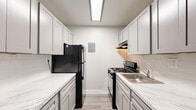 Located at 1293 Bayside Avenue in Woodbridge, VA, this single-floor home offers four bedrooms, one bathroom, and a well-organized layout making efficient use of its space. The interior is finished in a consistent neutral gray palette, creating a calm and cohesive atmosphere throughout.

The galley-style kitchen is a standout feature, showcasing updated gray shaker cabinetry paired with marble-look quartz countertops, a white subway tile backsplash, and wood-look flooring. Black appliances, including a gas range and full-size refrigerator, add a modern contrast to the light cabinetry.

The spacious primary bedroom is notably generous in size, featuring plush carpeting, a ceiling fan, a large sliding glass door with vertical blinds that invites natural light, and access to a dedicated closet. The three additional bedrooms are each carpeted and finished in the same soft gray tones, with windows fitted with vertical blinds providing natural light. Several bedrooms include their own closets for added storage.

The bathroom is clean and well-appointed, featuring a shaker-style vanity with white countertop, a tub-shower combination with tiled surround, and wood-look flooring. Four closets are distributed throughout the home, offering practical storage solutions. The overall design is simple, functional, and move-in ready.