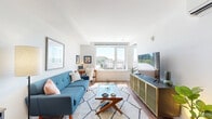 Located at 424 10th Ave S in Seattle's First Hill neighborhood, this thoughtfully laid-out one-bedroom, one-bathroom residence offers a compact yet highly functional floor plan across a single level. The space includes a living room, bedroom, bathroom, closet, and hallway — each room purposefully designed to maximize comfort and utility.

The bright living room is a standout area, featuring large windows that flood the space with natural light and frame views of the surrounding Seattle cityscape. Warm hardwood flooring runs throughout, complementing the clean, contemporary aesthetic. The open layout accommodates both a relaxed seating area and a dedicated workspace, making it equally suited for unwinding or working from home.

The bedroom offers a cozy retreat, highlighted by a bold olive-green accent wall that adds warmth and character. A large window frames an elevated city view, while direct access to a well-organized closet adds practical storage. Wall-mounted lighting flanks the bed, contributing to the room's functional and modern design.

The bathroom is finished with clean white walls, hardwood-style flooring, and a full tub-shower combination, providing a straightforward and well-appointed space.

Overall, this residence presents a modern urban aesthetic with quality finishes, ample natural light, and a well-considered layout suited for city living in Seattle.