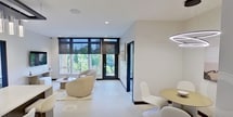 This contemporary 1020 sq ft apartment in Richmond Heights, OH offers a harmonious blend of style and functionality. The space boasts three bedrooms, including a primary bedroom of 150 sq ft, and two well-appointed bathrooms. The open-concept layout maximizes the single-floor design, creating a seamless flow between living areas.

The kitchen is a standout feature, showcasing sleek cabinetry, stainless steel appliances, and a large island with seating. Modern pendant lighting and a subway tile backsplash add visual interest. The living room is bathed in natural light from floor-to-ceiling windows, offering views of the surrounding area.

Bedrooms are thoughtfully designed with ample closet space, including a walk-in closet in the primary suite. Bathrooms feature modern fixtures, glass shower enclosures, and stylish vanities. The apartment's neutral color palette and clean lines create a sophisticated ambiance throughout.

Additional highlights include a dedicated media area, ceiling fans, and carefully curated decor that complements the modern aesthetic. With its prime location and high-end finishes, this apartment offers an ideal urban living experience.