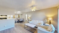 Located at 14531 Ella Blvd in Houston, TX, this 2-bedroom, 3-bathroom single-floor residence offers a well-organized and functional layout. The open-concept main living area seamlessly connects the living room, dining room, and kitchen, creating a bright and cohesive space. Light wood-look flooring flows throughout, complemented by neutral warm-toned walls and ceiling fans with integrated lighting in the main living areas and bedrooms. The living room features a sliding glass door that opens to a balcony, allowing natural light to fill the space. The galley-style kitchen is efficiently designed with white cabinetry, white countertops, a built-in sink, and black appliances including a refrigerator, electric range, and dishwasher. A pantry provides additional storage. The primary bedroom offers comfortable proportions, a ceiling fan, and access to a closet. Three well-appointed closets throughout the home, including a walk-in style with wire shelving, provide ample storage. The three bathrooms each feature tiled shower-tub combinations and light wood-look flooring. A dedicated laundry room houses a full-size washer and dryer with overhead wire shelving, adding everyday convenience to this practical and inviting Houston home.